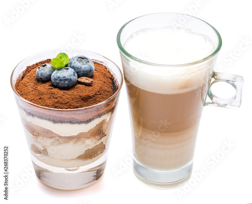 Classic tiramisu dessert with blueberries in a glass and cup of coffee isolated on a white background with clipping path