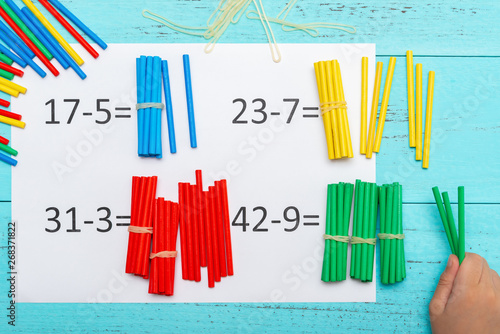 Картината върху платно kid doing subtraction equations using counting rods