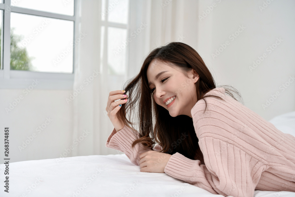 Relaxation concept. The beautiful girl is smiling happily inside the room. Beautiful Asian girl smiling cute and charming. Relaxation concept. The beautiful girl is smiling happily inside the room. Beautiful Asian girl smiling cute and charming.