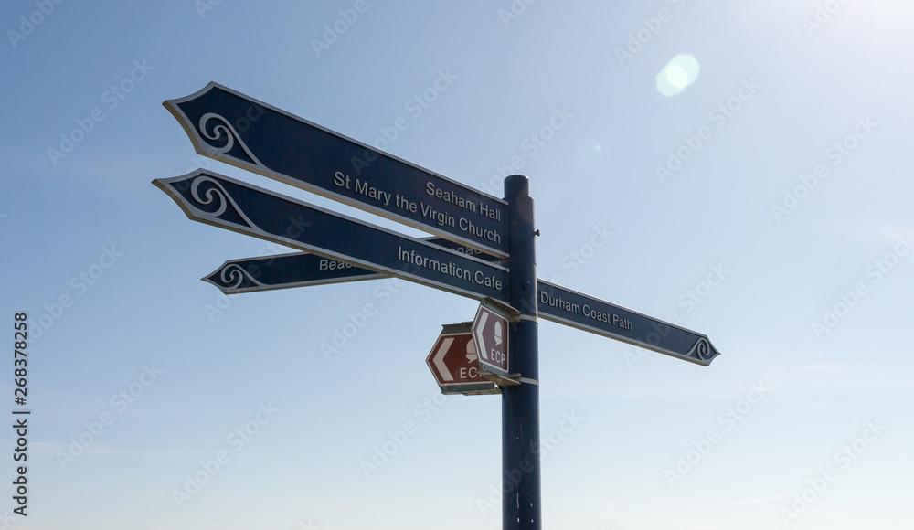 Directional Road Signpost indicating directions towards Seaham Hall Beach, Information Centre, Cafe, St Mary the Virgin Church and Durham Coast Path. Directional Road Signpost indicating directions towards Seaham Hall Beach, Information Centre, Cafe, St Mary the Virgin Church and Durham Coast Path.