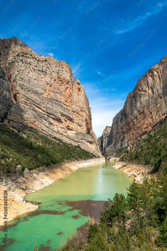 Mountain cliffs with scenci view of turquoise river and clear sky