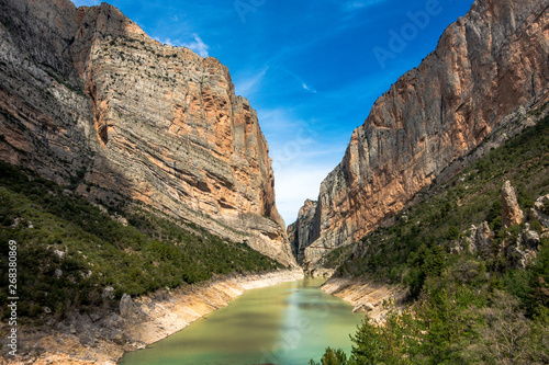 Mountain cliffs with scenci view of turquoise river and clear sky