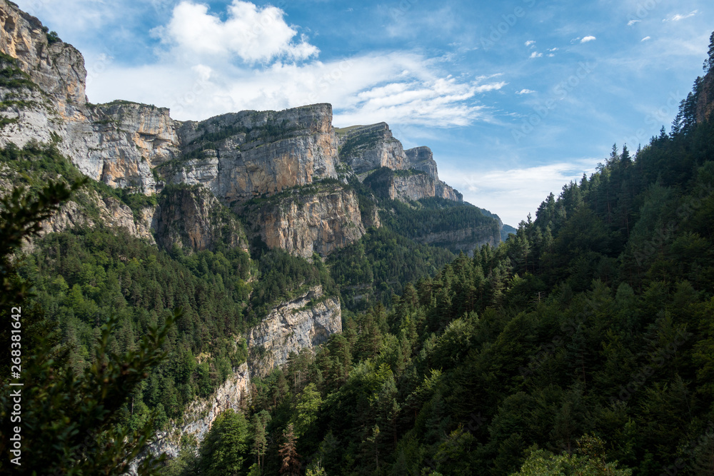 Scenic rocky mountains with deep forests and cliffs in Monte Perdido National Park, Spain