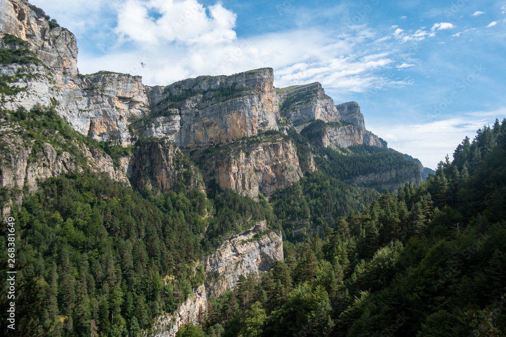 Scenic rocky mountains with deep forests and cliffs in Monte Perdido National Park, Spain