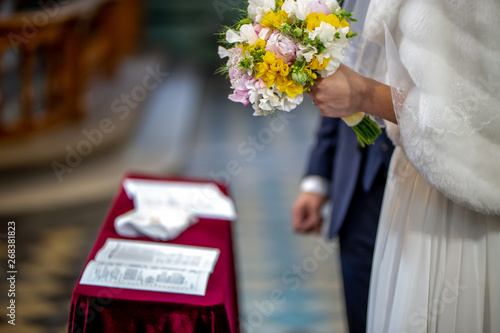 Bouquet of flowers in the hand of the bride during the marriage ceremony
