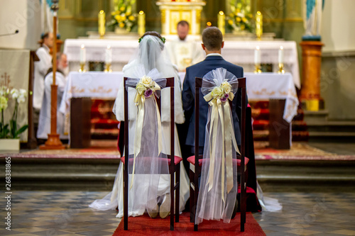 Bride and groom during wedding ceremony in church.