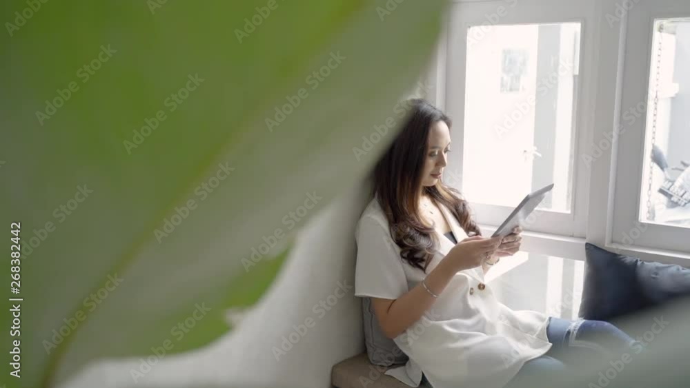beautiful relax woman using her gadget while sitting in cafe beautiful relax woman using her gadget while sitting in cafe