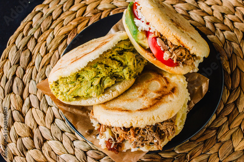 Arepas venezolanas is a traditional dish from Venezuela and Colombia, on a rustic background photo