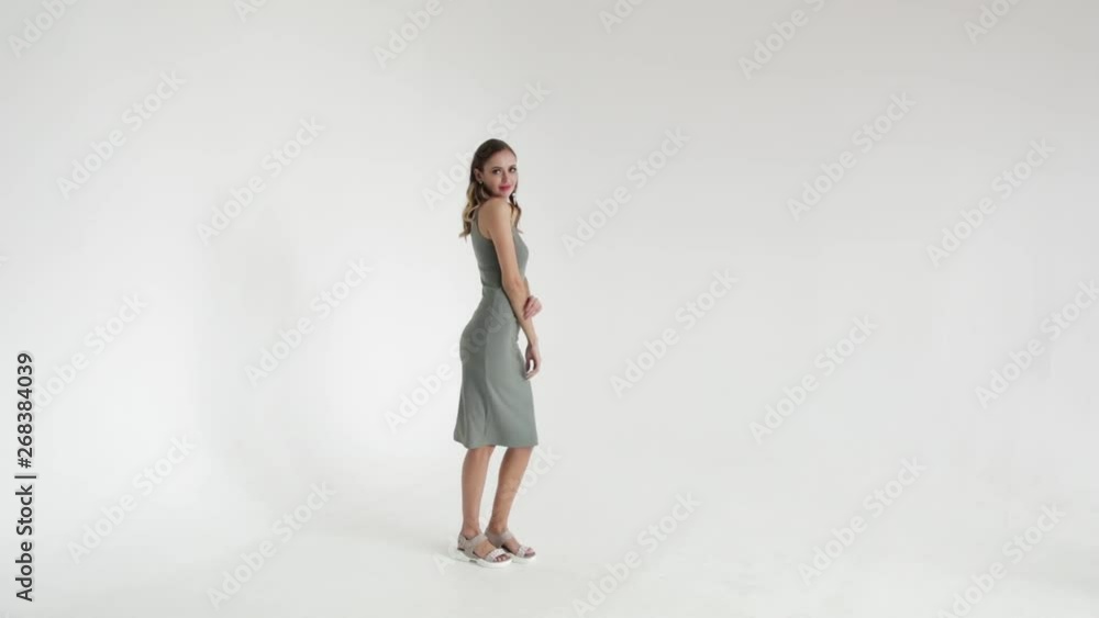 Elegant girl in green dress on white background posing and smiling , glamorous girl, fashion model Elegant girl in green dress on white background posing and smiling , glamorous girl, fashion model
