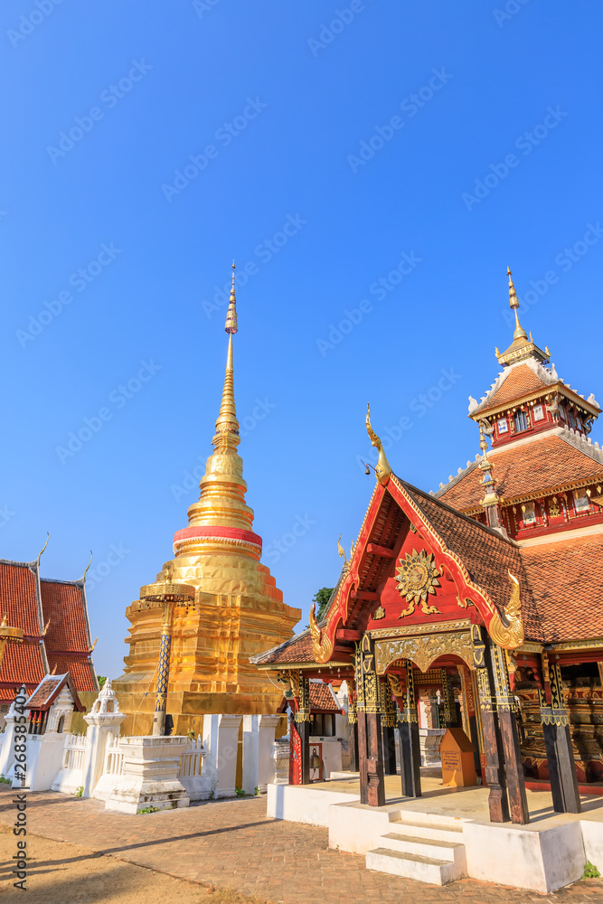 Golden pagoda and Buddha pavilion at Wat Pong Sanuk temple and museum in Lampang, North of Thailand