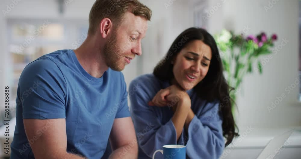 4K Happy couple relaxing at home at the weekend, looking at laptop together. Slow motion. 4K Happy couple relaxing at home at the weekend, looking at laptop together. Slow motion.