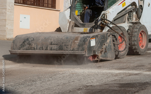 Sweeper attachments mini excavator. The sweeper sweeps, collects and dumps dirt and debris.