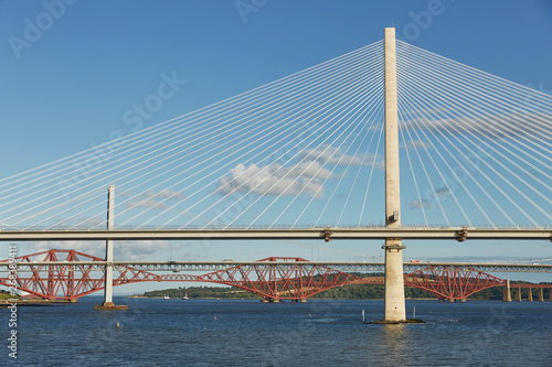 The new Queensferry Crossing bridge over the Firth of Forth with the older Forth Road bridge and the iconic Forth Rail Bridge in Edinburgh Scotland.
