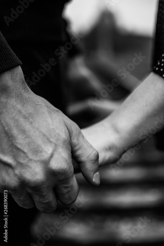 the couple holding hands at the railway