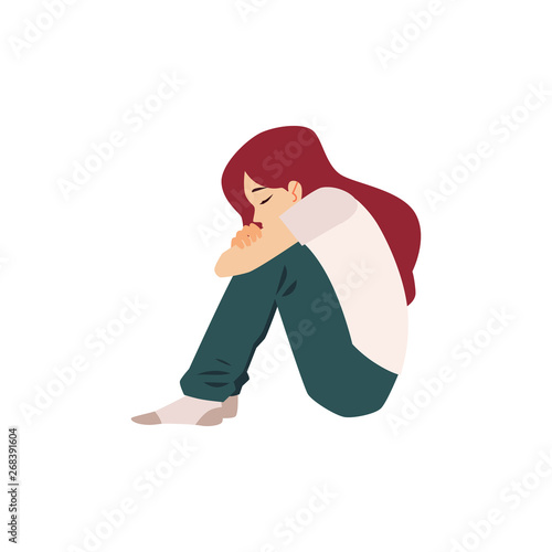 Lonely woman sits on the floor suffering from depression or relationship break.