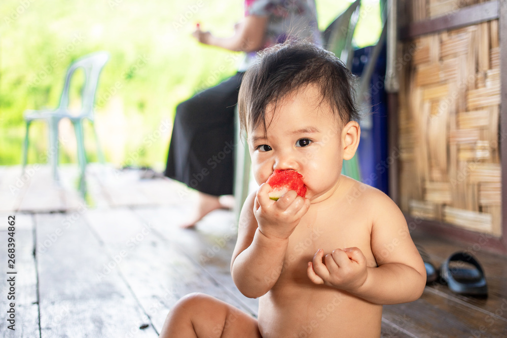 Cute Asian baby girl eating watermelon, Female kid enjoy eating watermelon Cute Asian baby girl eating watermelon, Female kid enjoy eating watermelon