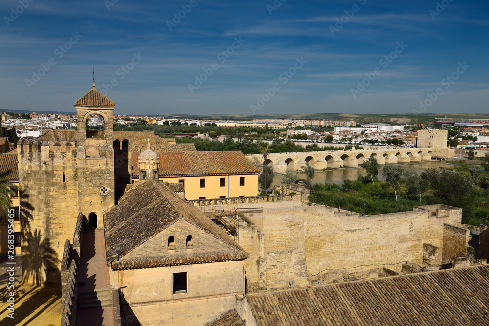View of Tower of Homage and Roman Bridge over Guadalquivir river from Tower of Lions Alcazar Cordoba
