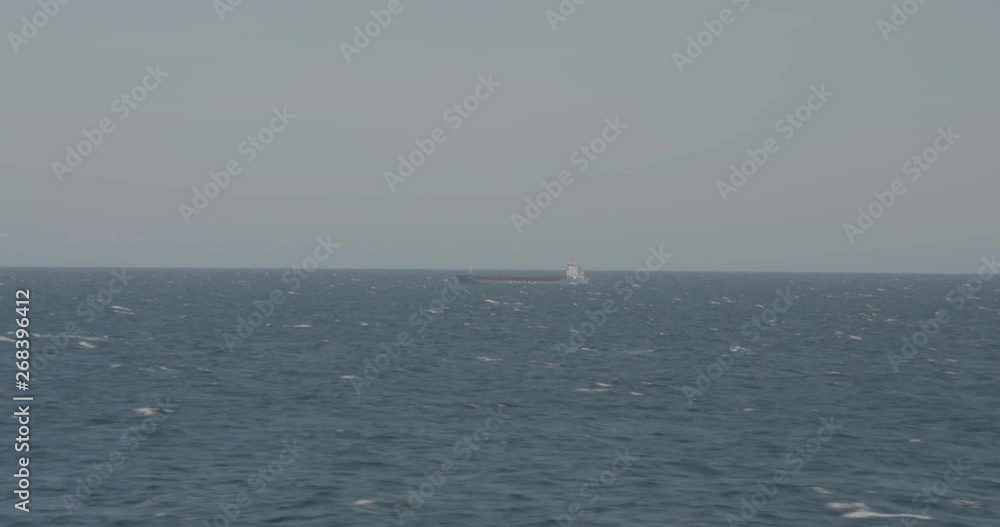 passing ship at see, choppy waves, blue coaster. passing ship at see, choppy waves, blue coaster.