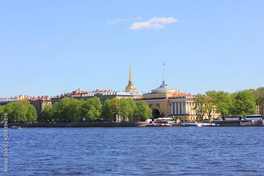 Admiralteyskaya embankment with Admiralty building on summer day view across Neva river water 