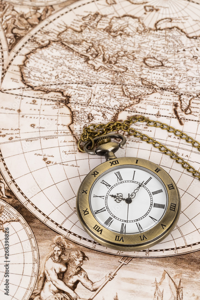 Vintage pocket watch clock on ancient map background