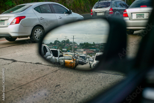 cars city traffic in Latinoamerica, traffic jams, a stream of cars on mirror