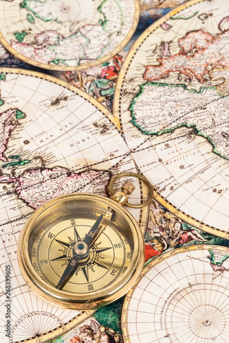 Compass on vintage ancient map  concept for direction transportation and travel