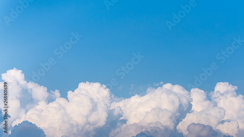 Top of white fluffy clouds and blue sky background