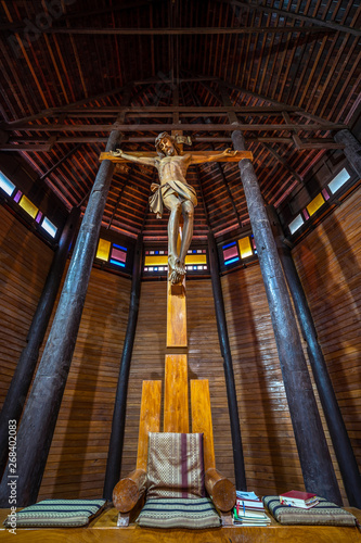 YASOTHON, THAILAND - APRIL 1, 2019 : The largest wooden Christian church in Thailand and up to 100 years old, Ban Song Yaeng Church, Yasothon Province, built in Thai style.. photo