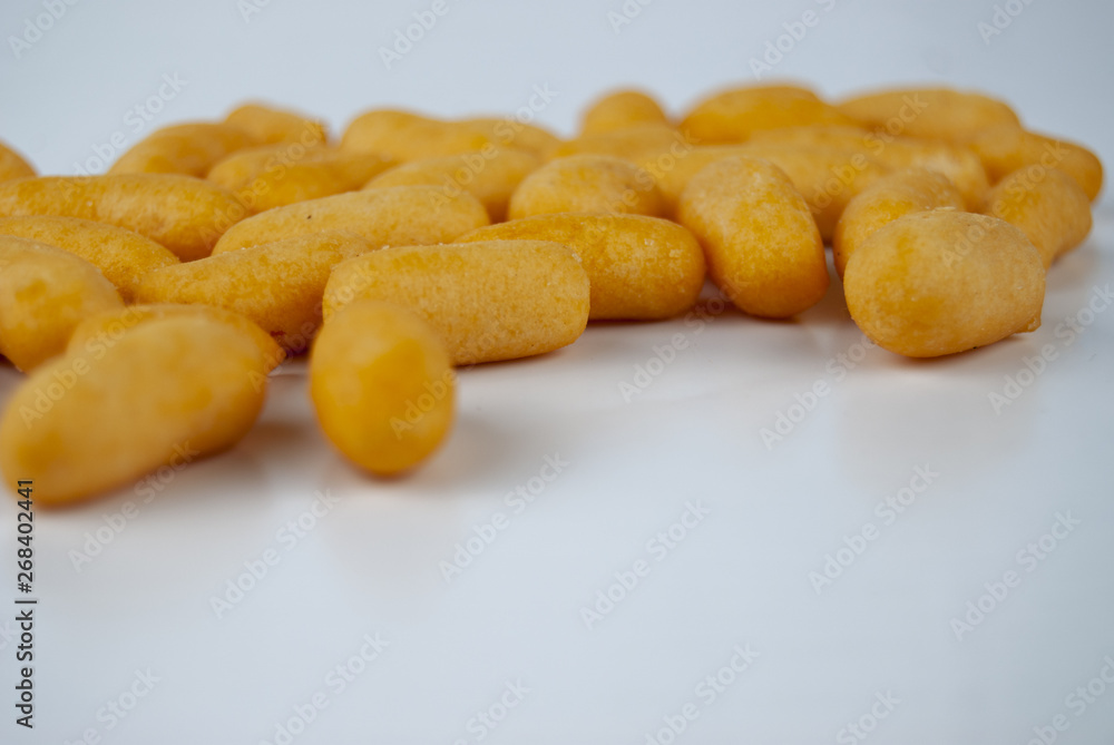 snack crisps chip yellow from fish flavored in capsule shape ellipse on plain isolated white background snack crisps chip yellow from fish flavored in capsule shape ellipse on plain isolated white background