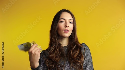 Carefree young woman holding stack of money and boasting her savings. Business, income, success concept. Slow motion
