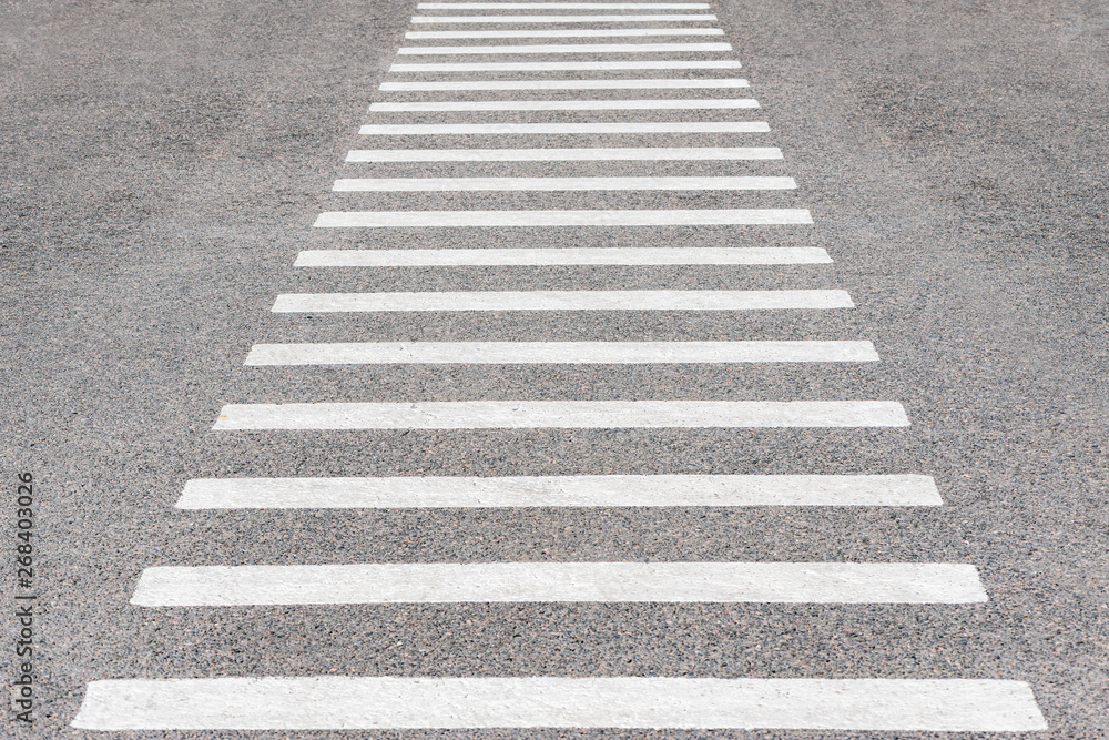 White lines on the asphalt on the crossroad. White lines on the asphalt on the crossroad.