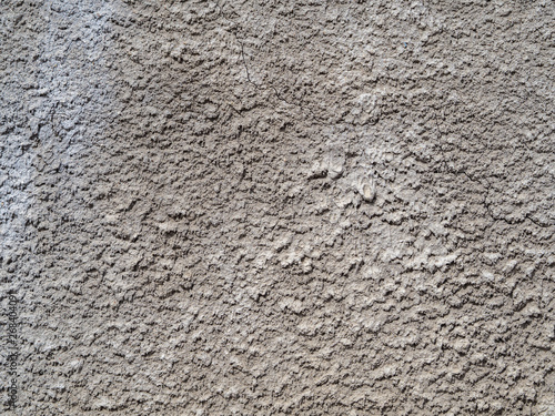The old gray plaster is covered with cracks  scratches.