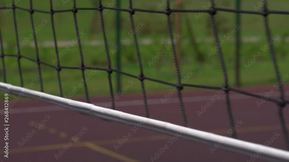 Volleyball net on a background of blue sky on a sunny day. Close-up. Camera movement. Playground in the city park Volleyball net on a background of blue sky on a sunny day. Close-up. Camera movement. Playground in the city park
