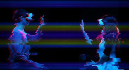 Couple of people communicate using a virtual reality headset. Image with glitch effect.