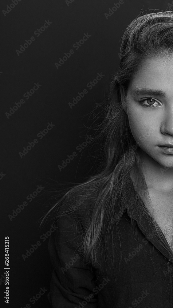 Beautiful woman face studio black and white half-face