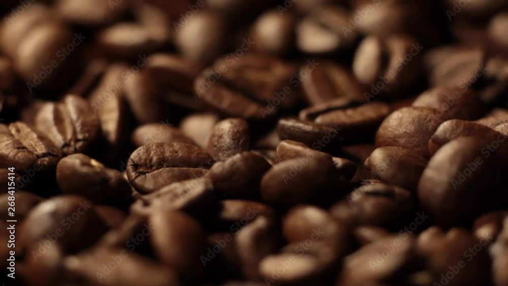 Beans of Coffee Raining at Slow Motion. Morning black coffee texture. Coffee beans factory mixing, close up. Roasted coffee bean. Beans of Coffee Raining at Slow Motion. Morning black coffee texture. Coffee beans factory mixing, close up. Roasted coffee bean.