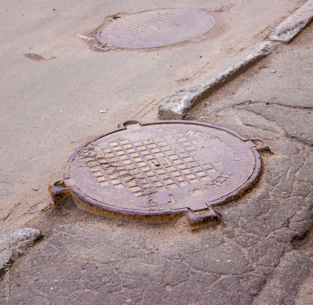 round rusty cast iron drain well hatch