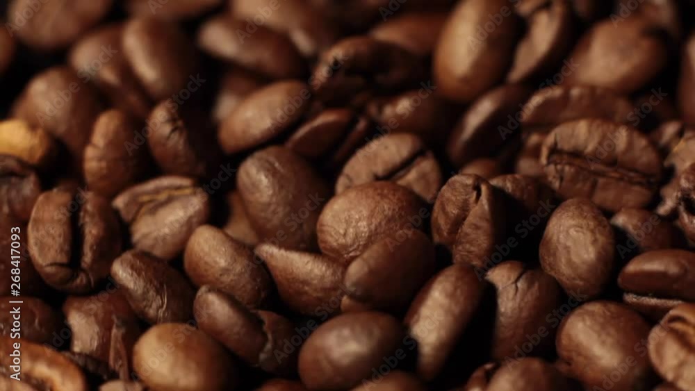 Coffee beans factory mixing, close up. Roasted coffee bean. Beans of Coffee Raining at Slow Motion. Morning black coffee texture. Coffee beans factory mixing, close up. Roasted coffee bean. Beans of Coffee Raining at Slow Motion. Morning black coffee texture.