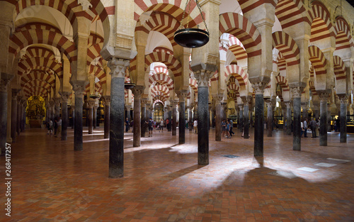 Double red and white arches on ancient Roman columns at the Prayer Hall in the Cordoba Cathedral Mosque