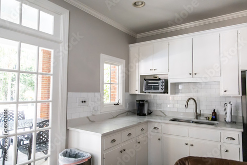 Small White Kitchen in a Cottage Apartment Pool House