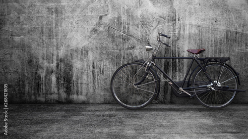 Retro vintage black bike on old brick wall.