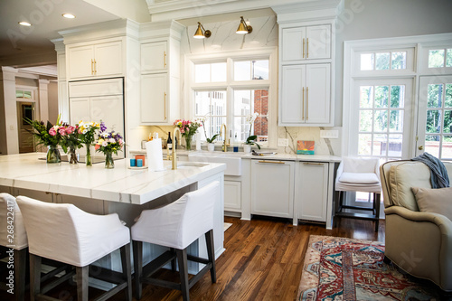 Open Concept Elegant and Spacious Kitchen with Marble Countertops  Chandelier  and Two Toned Cabinets