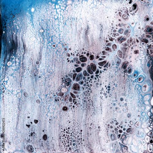 Very beautiful texture background. White paint flows in blue with the addition of black paint. Style includes curls of marble or agate with bubbles and cells. Natural style.