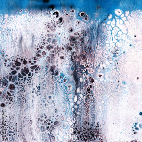 Very beautiful texture background. White paint flows in blue with the addition of black paint. Style includes curls of marble or agate with bubbles and cells. Natural style.