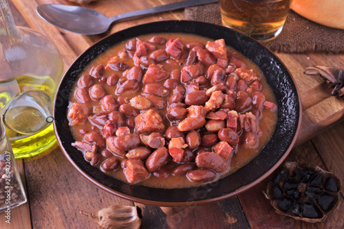 dish of red beans cooked on classic wooden table photo