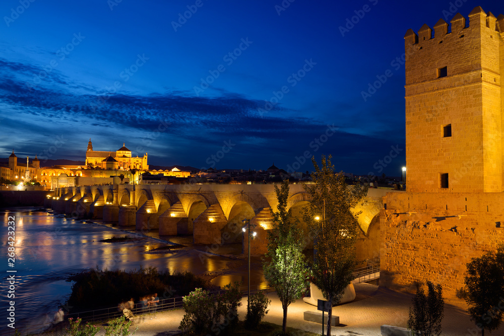 Calhorra Tower gate for Roman Bridge over the Guadalquivir River with Cordoba Cathedral Mosque at dusk