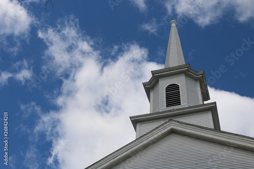 White wooden church steeple in historic New England town