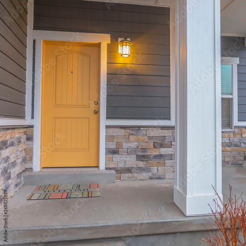 Square Entryway of a home with stairs going up to the front porch and door photo