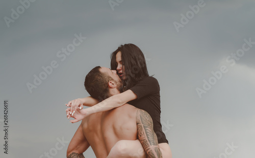 Love story. Beautiful young couple hugging. Couple is hugging. Passion love couple. Handsome muscular guy and amazing sexy woman. Cosmopolitan couple. Love and flirt. photo