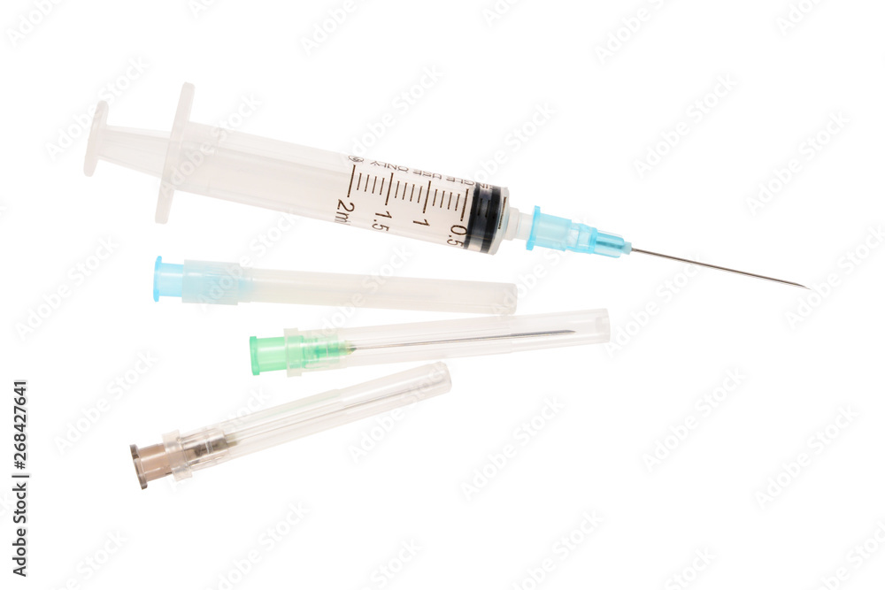 Fototapeta premium Syringe and three needles in plastic shells. 2 ml disposable syringe close up, isolated on white background without shadow